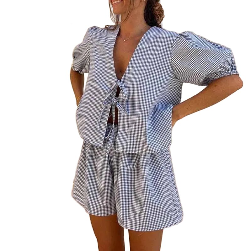Woman in a blue checked tie-front short puff-sleeve top and matching shorts set, front view