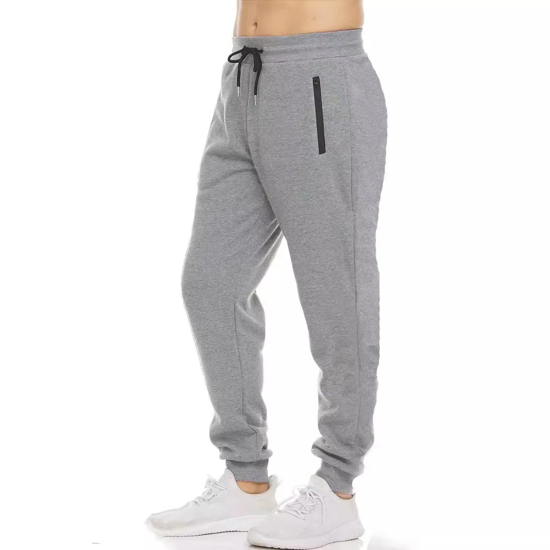 Light gray drawstring jogger sweatpants with a zip pocket and tapered legs, front view