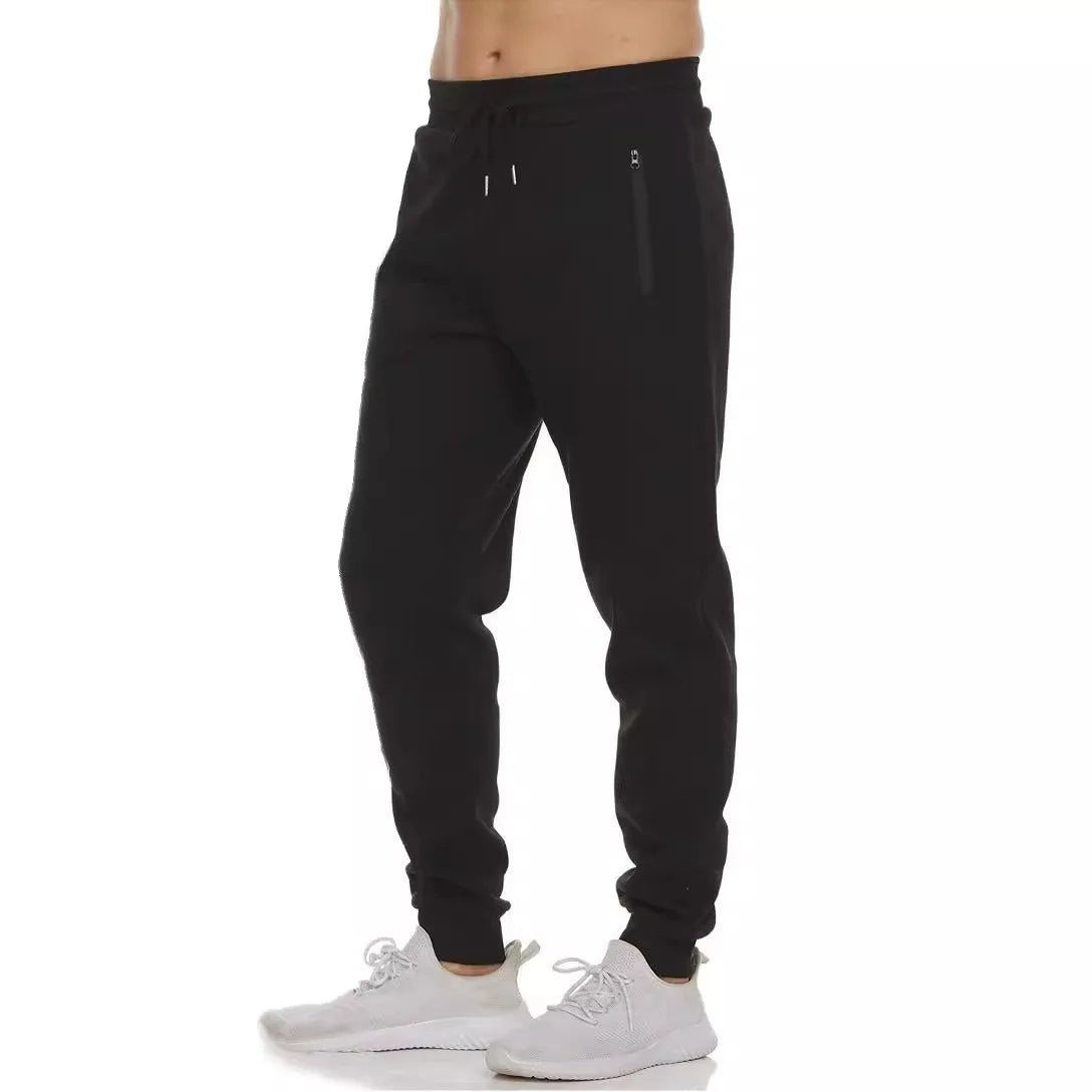 Black drawstring jogger sweatpants with zip pockets and tapered legs, front view
