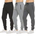 Black, light grey and dark grey jogger sweatpants side by side with white sneakers