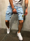 Men's light blue distressed denim cargo shorts with a thigh pocket, worn with a white t-shirt and white sneakers