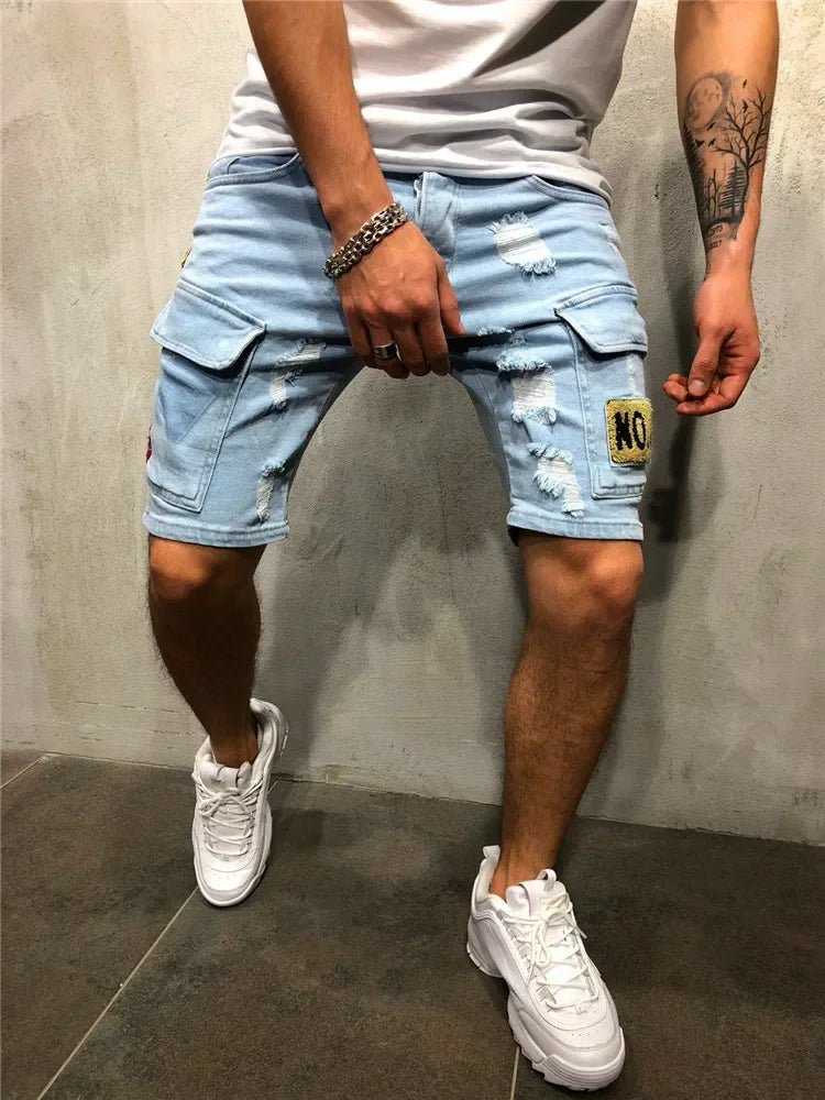 Men's light blue distressed denim cargo shorts with a thigh pocket, worn with a white t-shirt and white sneakers