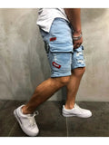 Men's light blue denim shorts worn from the side, showing a thigh pocket and red patch details
