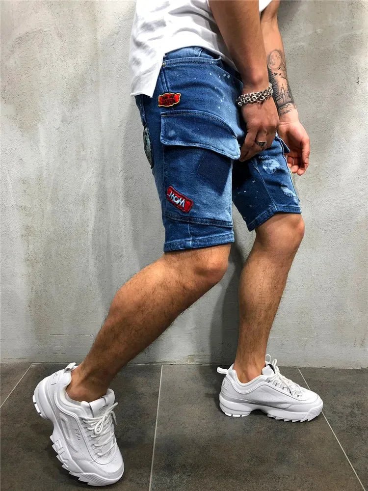Men's dark blue denim cargo shorts worn from the side, with a red patch on the thigh pocket