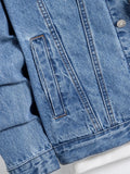 Close-up of a denim jacket side pocket, buttoned cuff and hem