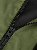 Close-up of a black zip with a silver pull on a green jacket