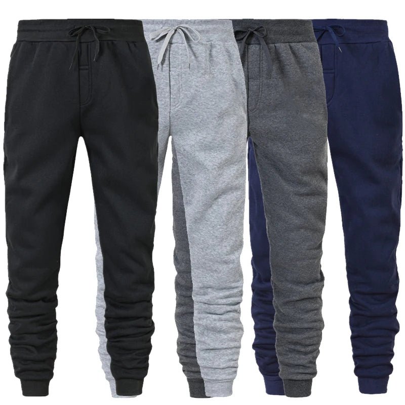 Four pairs of drawstring jogger sweatpants in black, light grey, dark grey and navy side by side