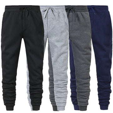 Four pairs of drawstring jogger sweatpants in black, light grey, dark grey and navy side by side