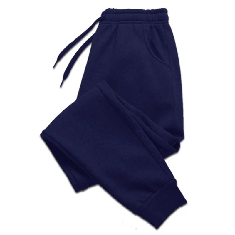 Blue jogger sweatpants laid flat with drawstring waist and ribbed ankle cuffs