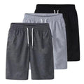 Stack of three drawstring shorts in dark grey, light grey and black shown together