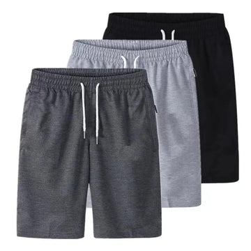 Stack of three drawstring shorts in dark grey, light grey and black shown together