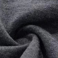 Close-up of dark grey brushed-looking fabric texture in a soft swirl