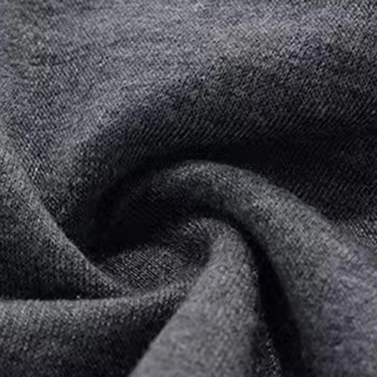Close-up of dark grey brushed-looking fabric texture in a soft swirl