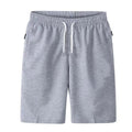 Light grey drawstring shorts with side pockets, shown from the front