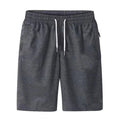 Dark grey drawstring shorts with side pockets, shown from the front
