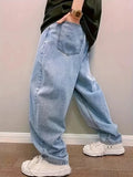 Back view of light blue washed baggy jeans showing back pockets, worn with white sneakers