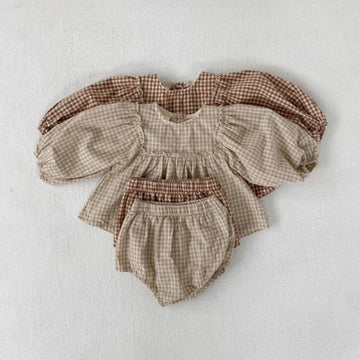 Beige and apricot gingham baby tops with matching bloomers laid flat together
