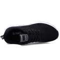 Top and side view of a black knit sneaker with a small label on the tongue and thick white sole