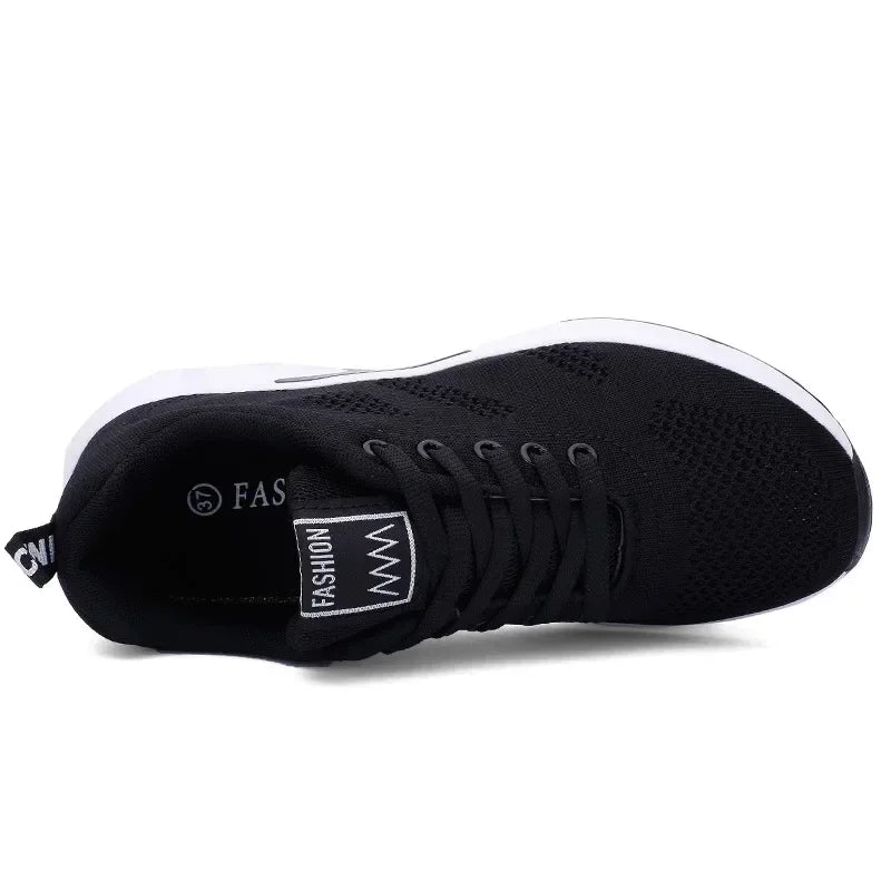 Top and side view of a black knit sneaker with a small label on the tongue and thick white sole