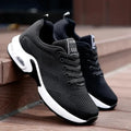 Black lace-up sneakers with a white cushioned sole and heel window seen from the side