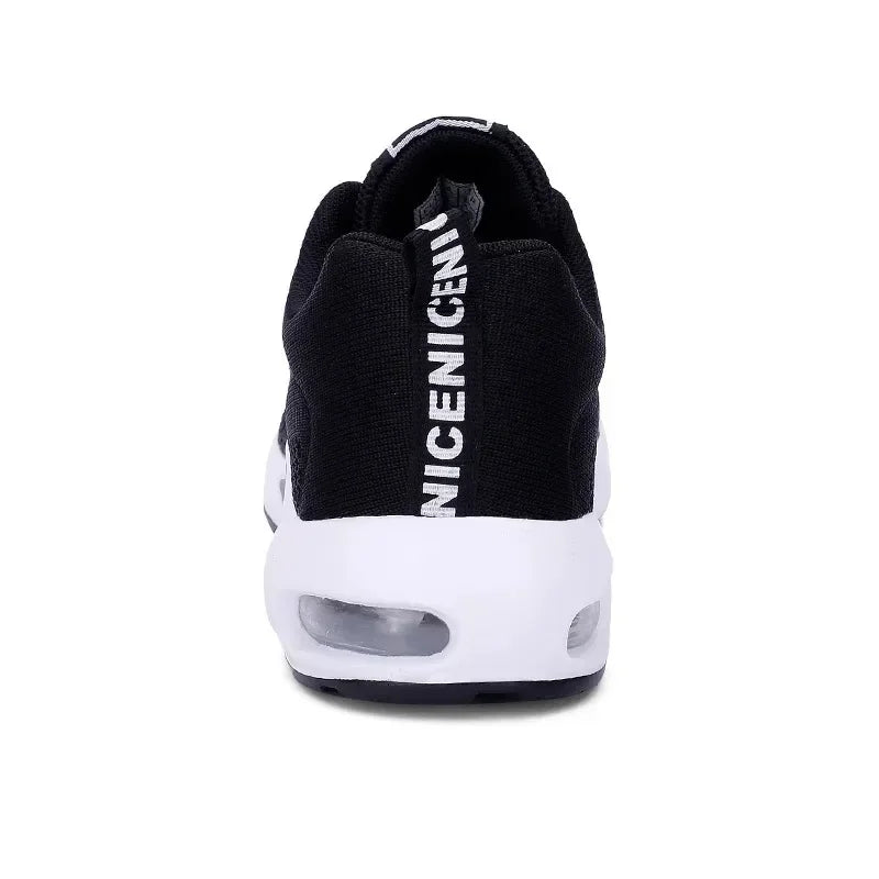 Back view of a black sneaker with printed lettering on the heel tab and a white air-cushion sole