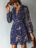 Navy floral mini dress with a V-neck, sheer long sleeves and a gathered waist, front view