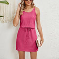 Woman in a rose pink sleeveless mini dress with a drawstring waist, rose colour option