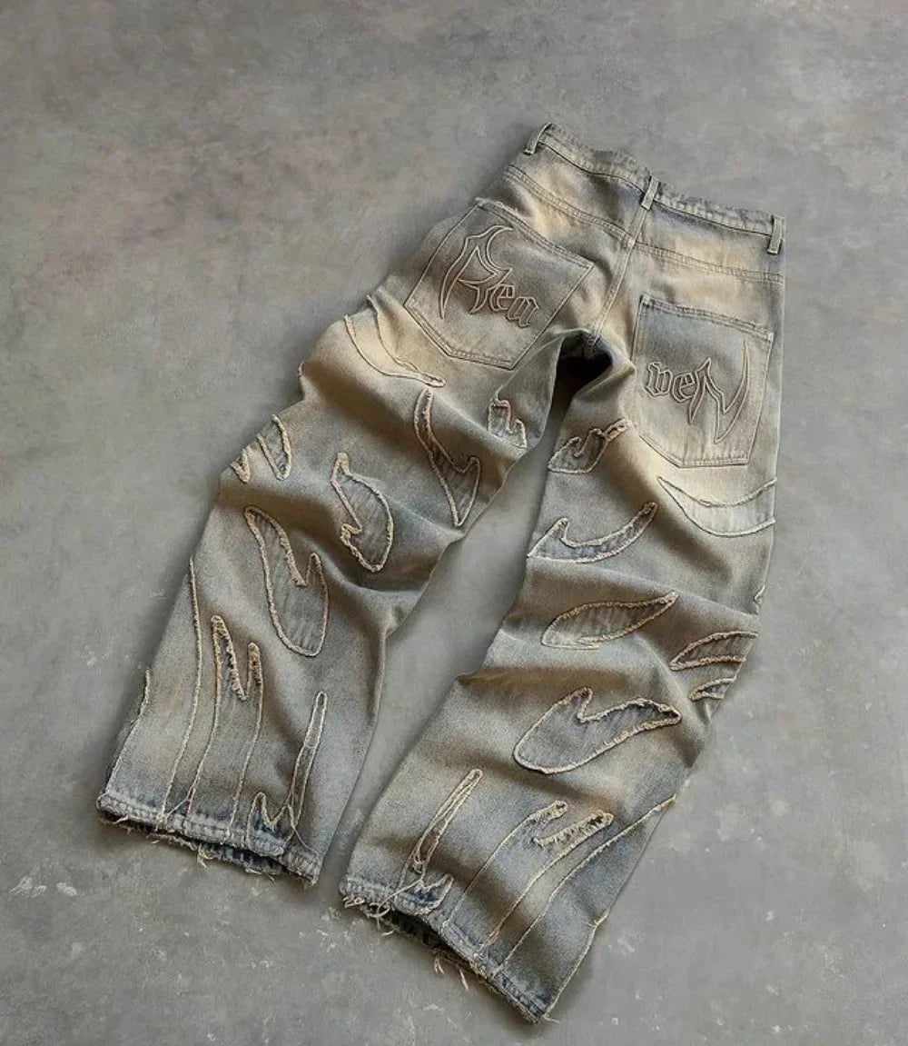 Tan washed baggy wide-leg jeans with frayed thread-line texture and a raw hem