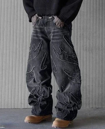 Man in black washed baggy wide-leg jeans with a dark top and boots, front view